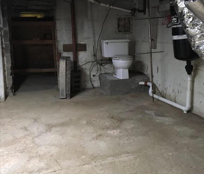 corner of concrete basement free of debris and sewage