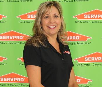 female employee sitting in front of SERVPRO backdrop