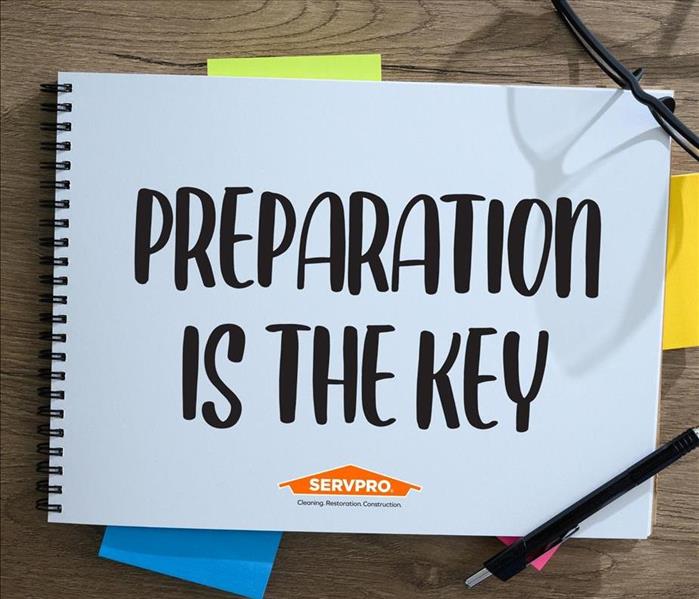 notepad that says "preparation is the key" and SERVPRO logo