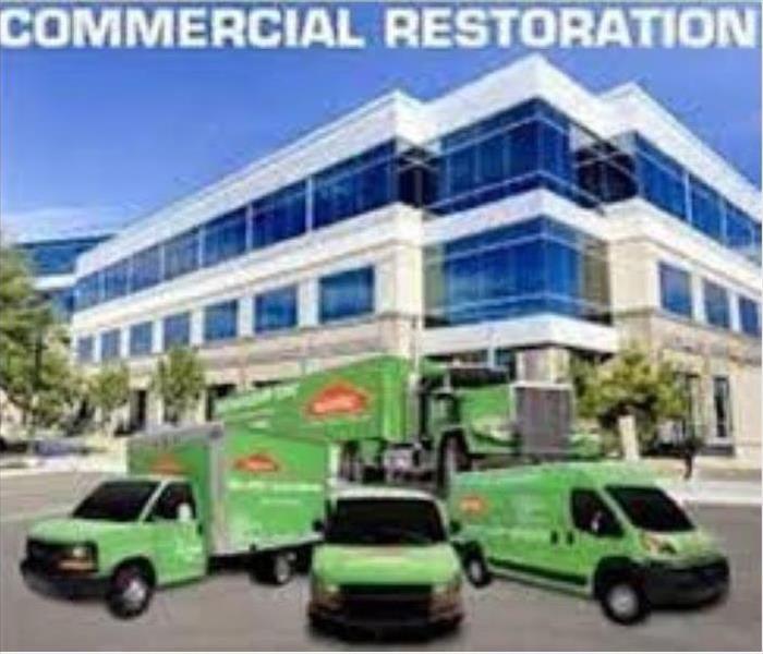 large commercial building with SERVPRO vehicles parked out front