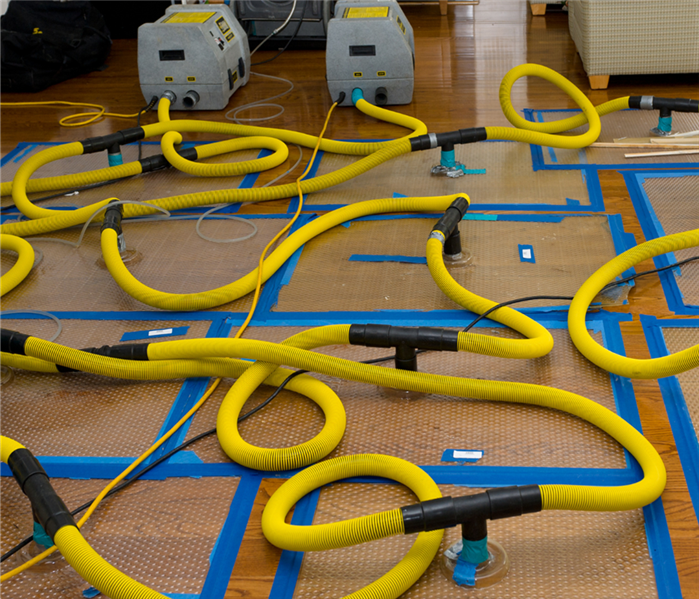 Vacuums suction cupped to the floor to suck out excess water.