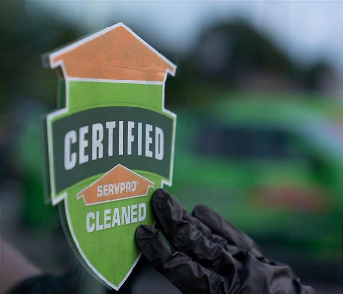 Image of Certified: SERVPRO Cleaned Program sticker on a glass door.