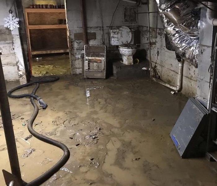 corner of a concrete basement soiled with sewage contents