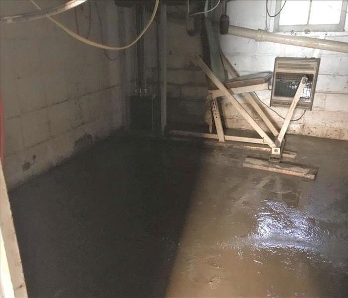 corner of concrete basement with sewage contents on the ground 