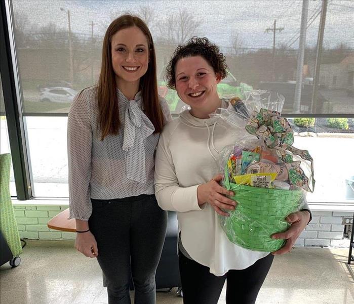 Female SERVPRO employee with female Easter giveaway winner