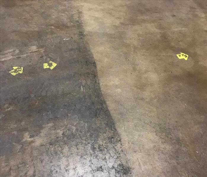 concrete floor with dirt on one side and cleaned on the other 