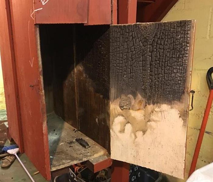 wooden door with soot and smoke damage