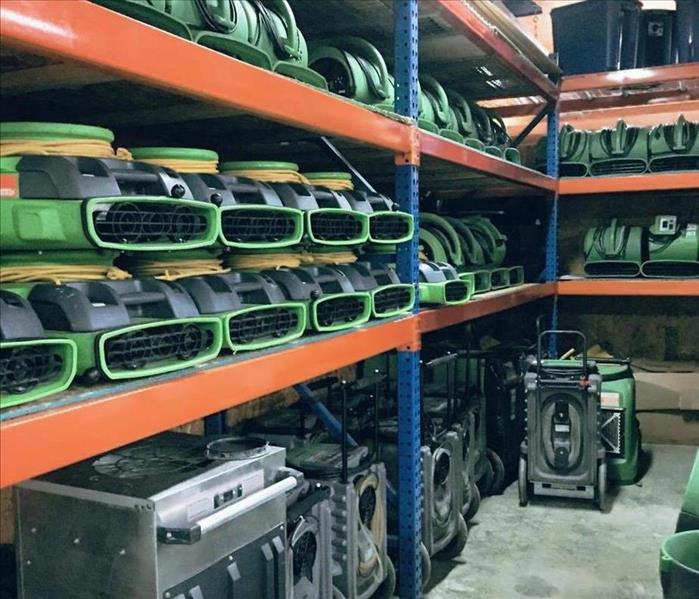Stacks and rows of air movers in warehouse